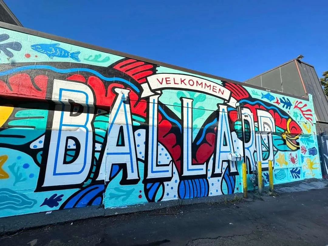 The Ballard neighborhood mural with "Velkommen" written above it, sunny in Seattle in August.