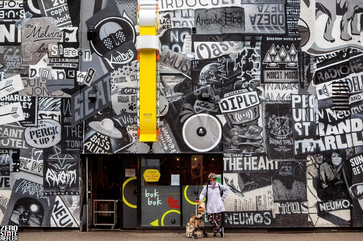 Vibrant street art and a colorful mural decorate a storefront exterior in urban Capitol Hill Seattle.