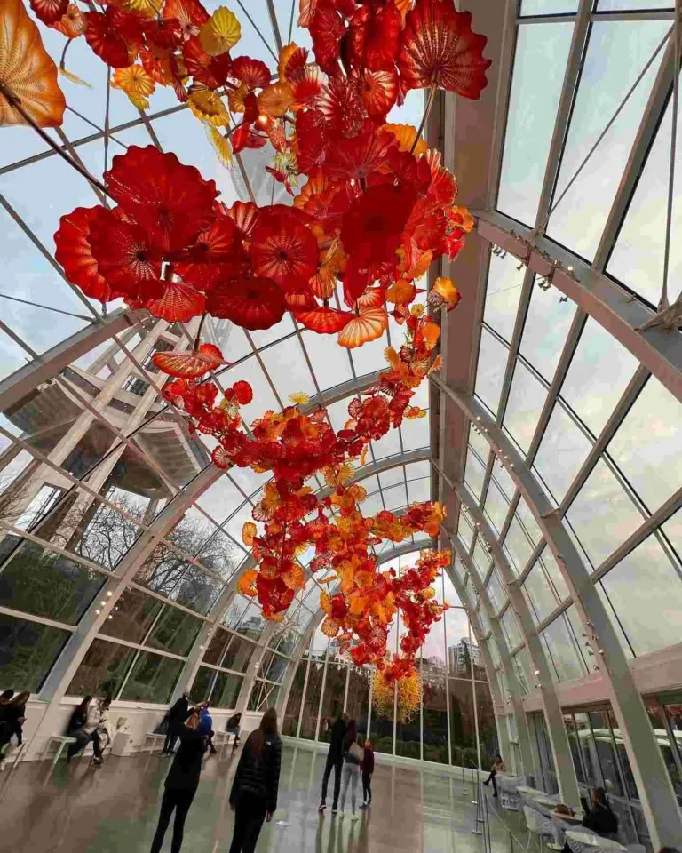 A large glass conservatory structure with Chihuly's bright glass flowers in Seattle in April.