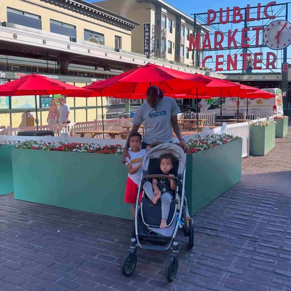 A father and his two young children enjoy getting around Seattle while visiting Pike Place Market.