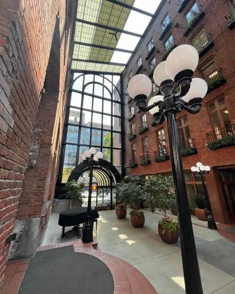An indoor courtyard with brick walls and globe streetlights near the historic International District Seattle.