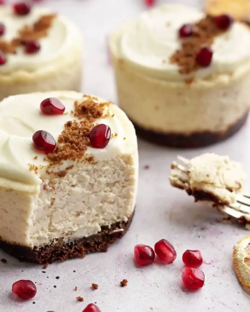 Mini cheesecakes with white frosting, pomegranate seeds, and graham cracker crumbs in Belltown Seattle.