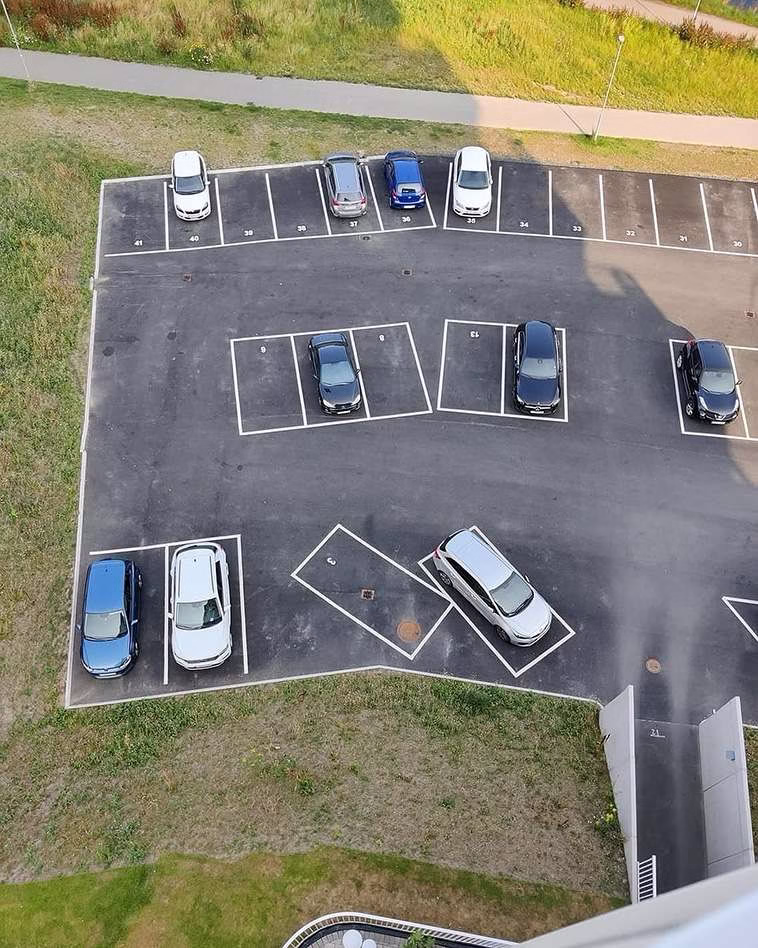 Aerial view of cars in a confusingly marked lot, highlighting the struggle of getting around Seattle.