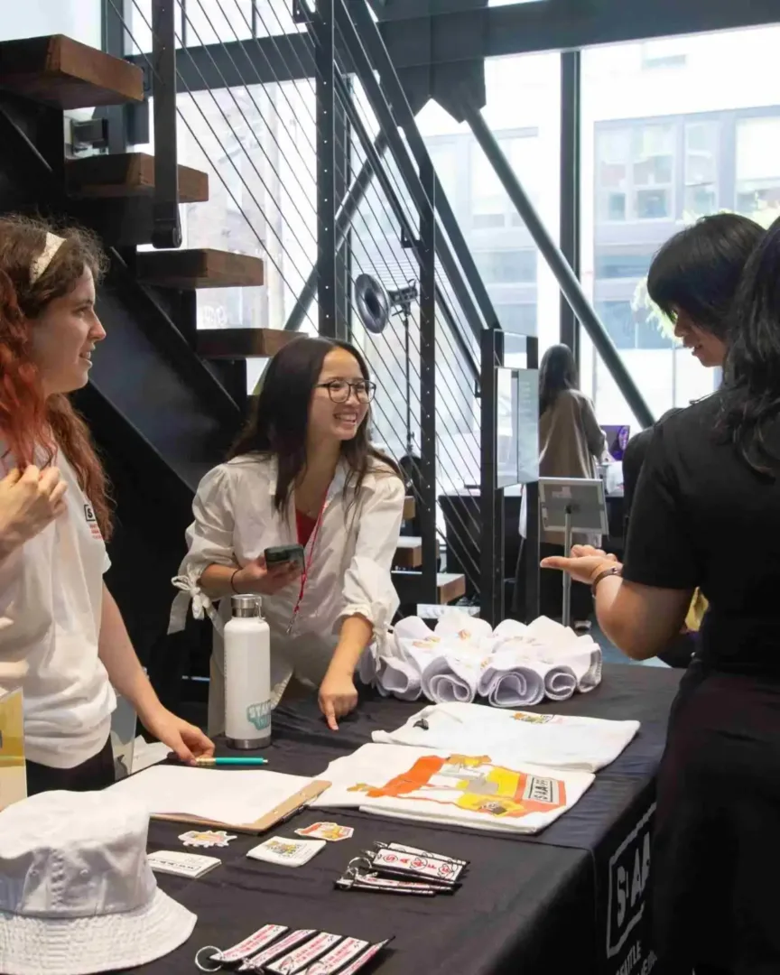 People gather at a merchandise table inside the Wing Luke Museum in the International District Seattle.