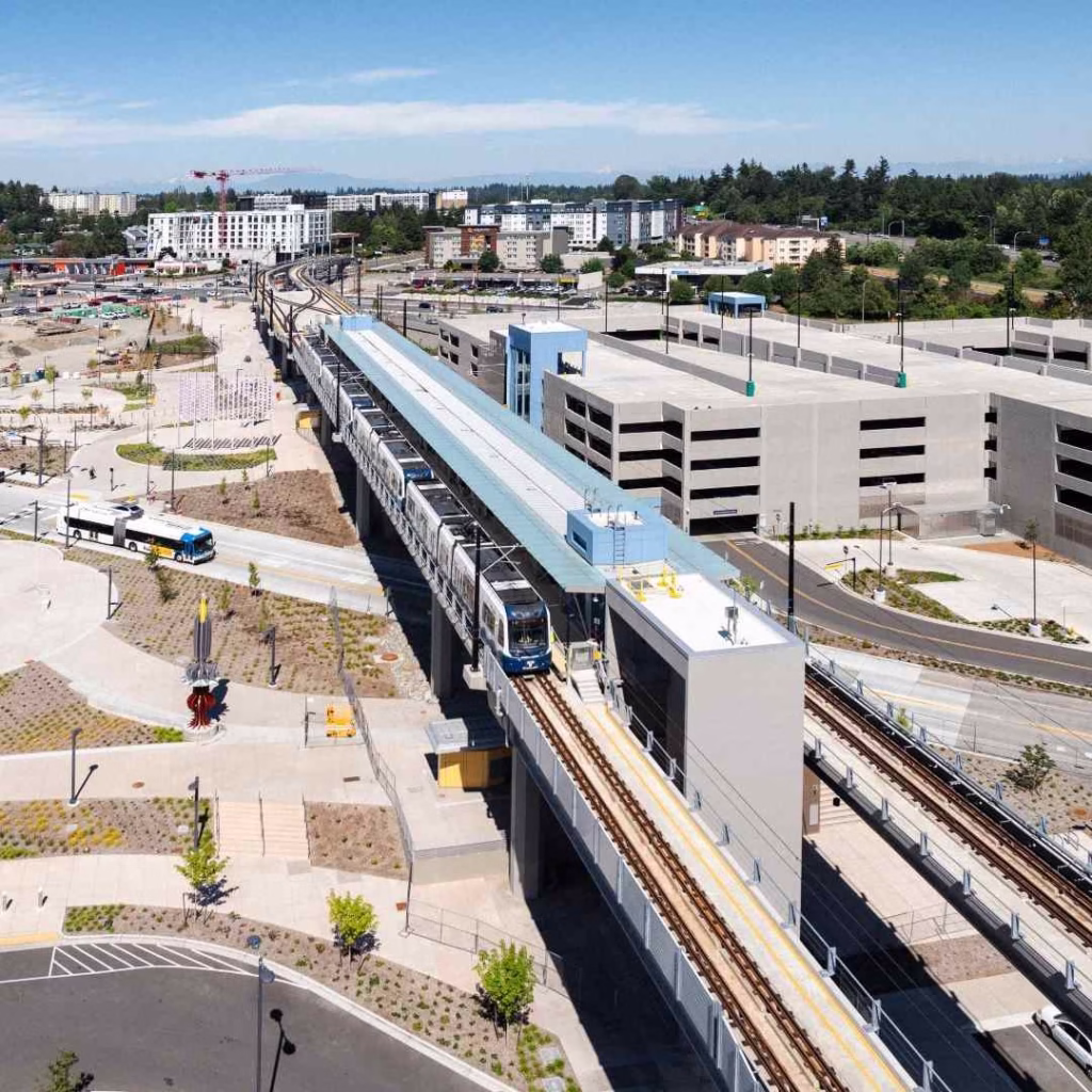 Aerial view of a Link Light Rail train at a station, efficient for getting around Seattle.