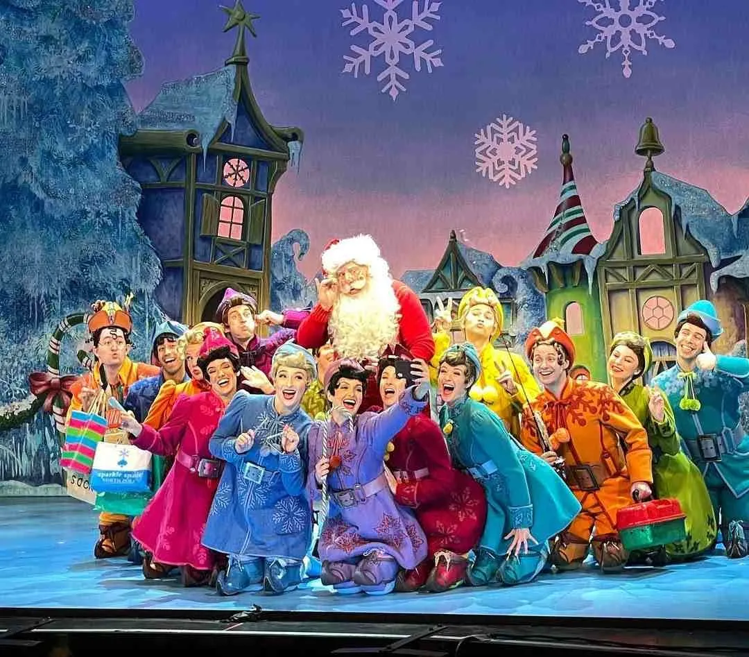 Cast of Elf The Musical posing for Santa's selfie as featured in Seattle Theater Guide.