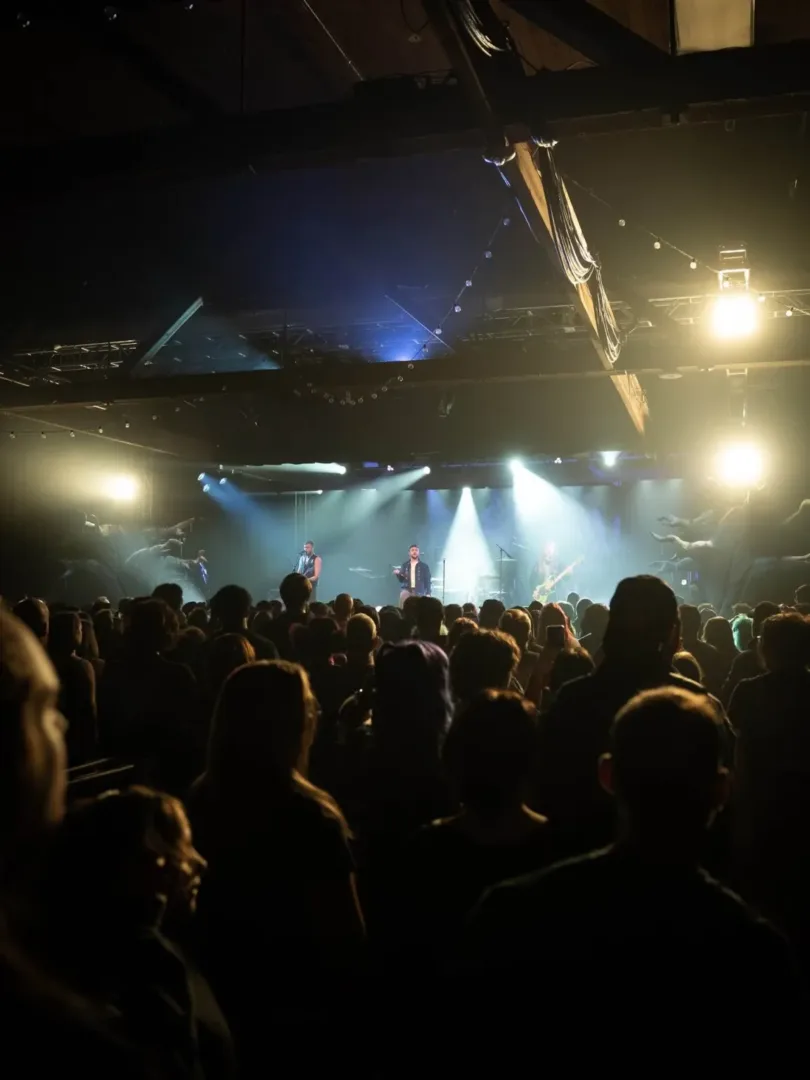 A rock band performs on stage under bright lights, representing the iconic Seattle music scene.
