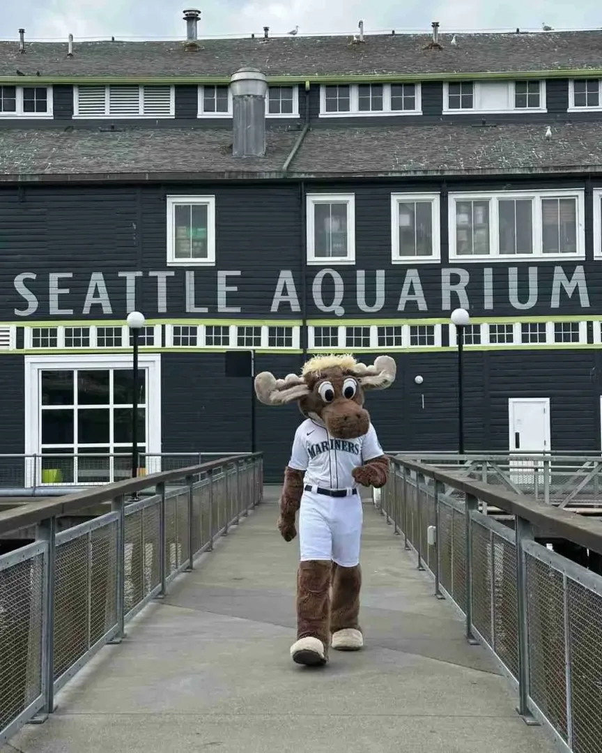 A moose mascot walks outside the aquarium, a fun stop on your Chihuly Garden and Glass guide.